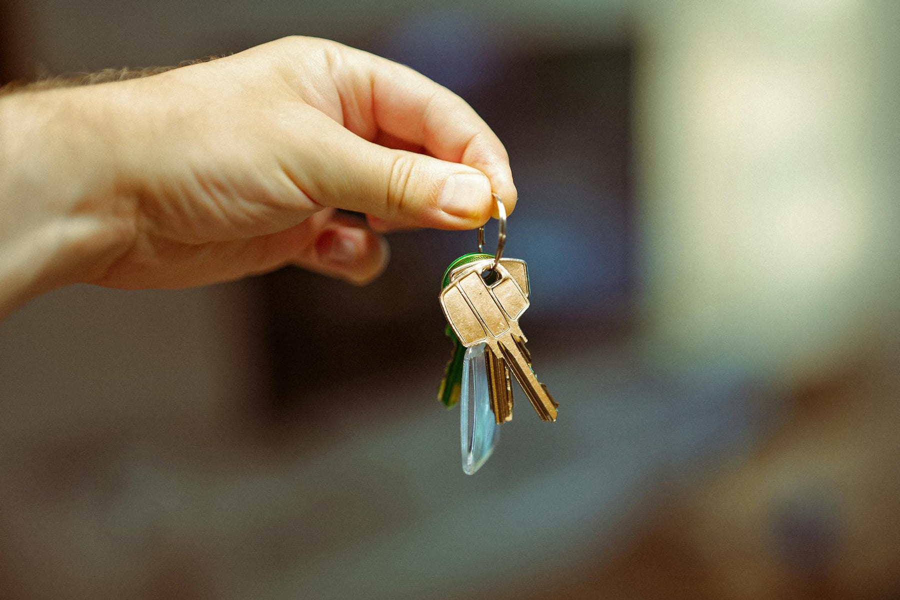 A close-up image of a hand holding a keyring with several house keys, symbolizing real estate and home ownership. on The Smart Home Buyer