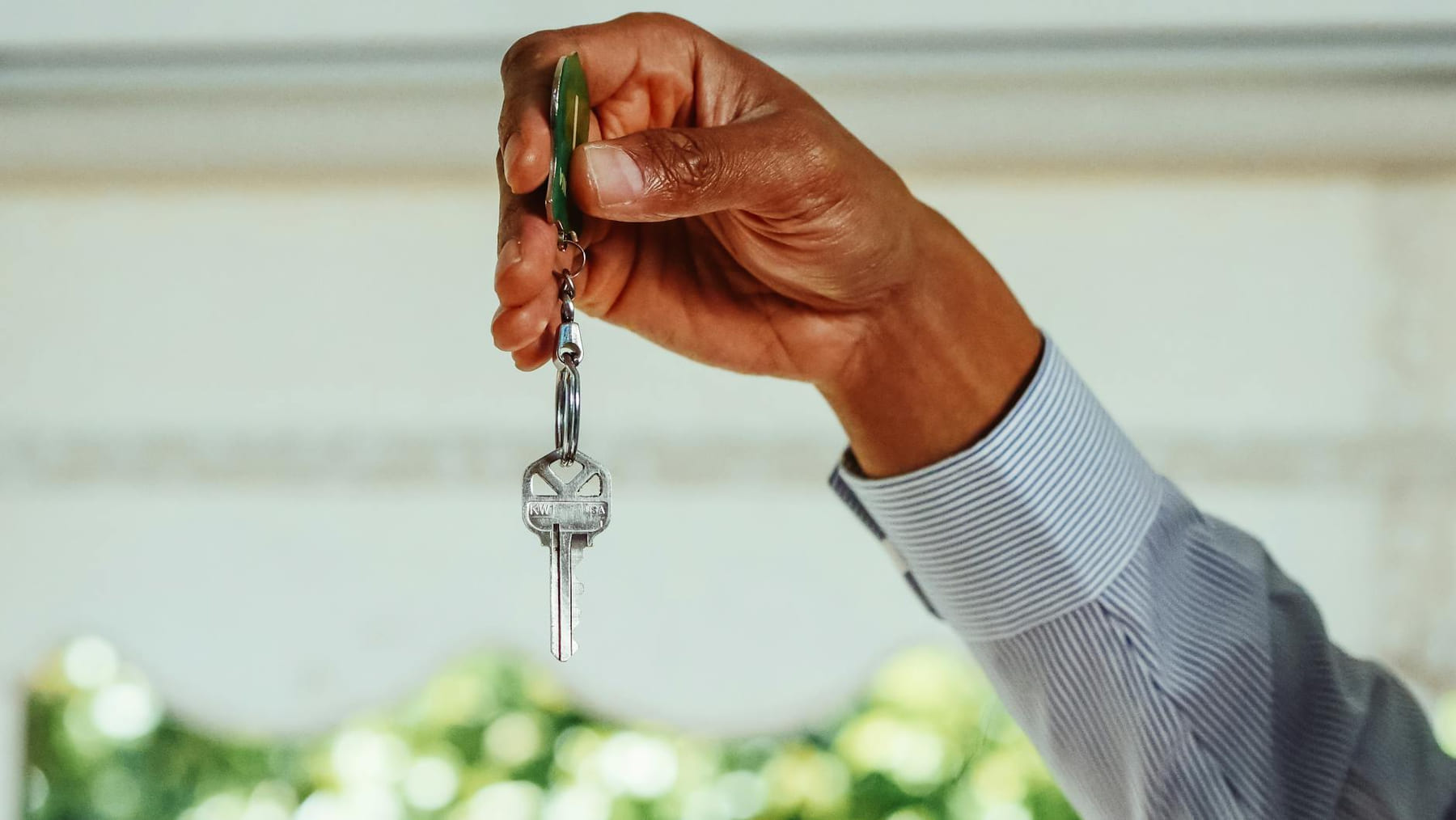 A hand holding a set of house keys, symbolizing buying or renting a new home. on The Smart Home Buyer