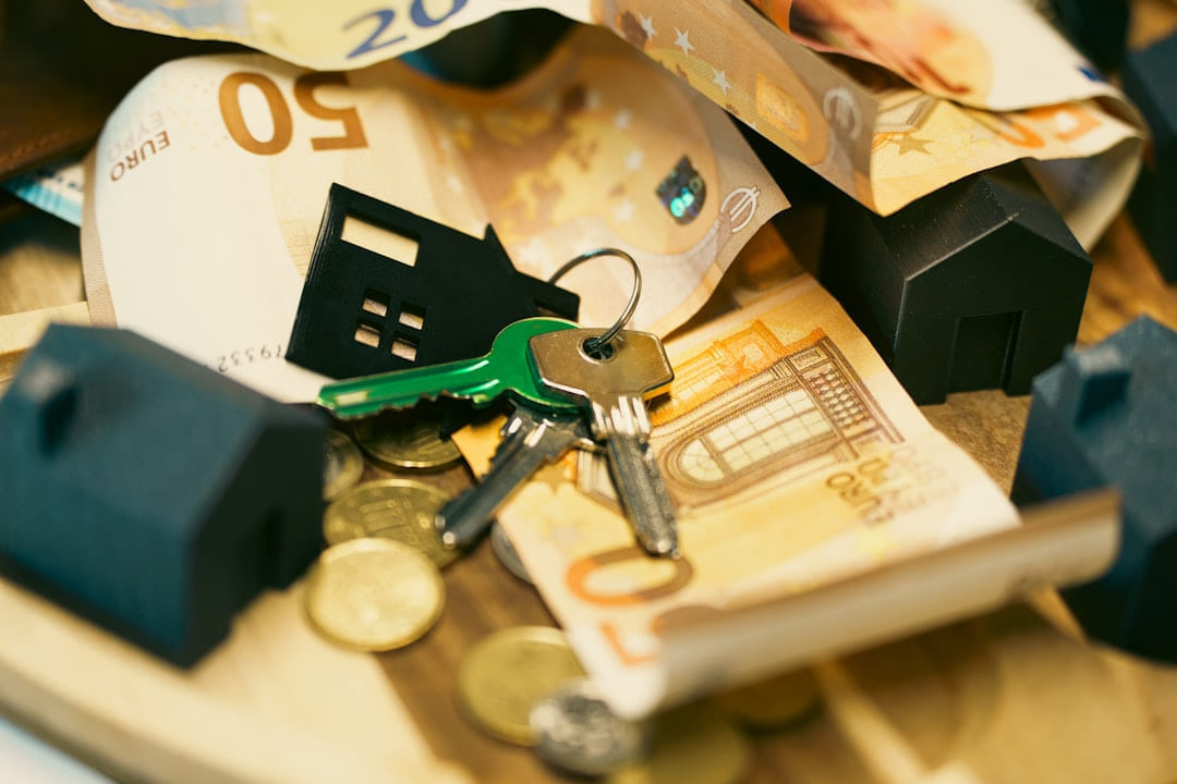 Money, keys, and miniature houses depict homeownership. on The Smart Home Buyer
