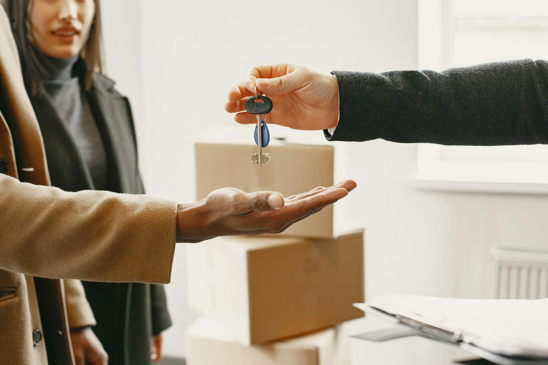 A new homeowner receives keys inside their new home, symbolizing a fresh start. on The Smart Home Buyer