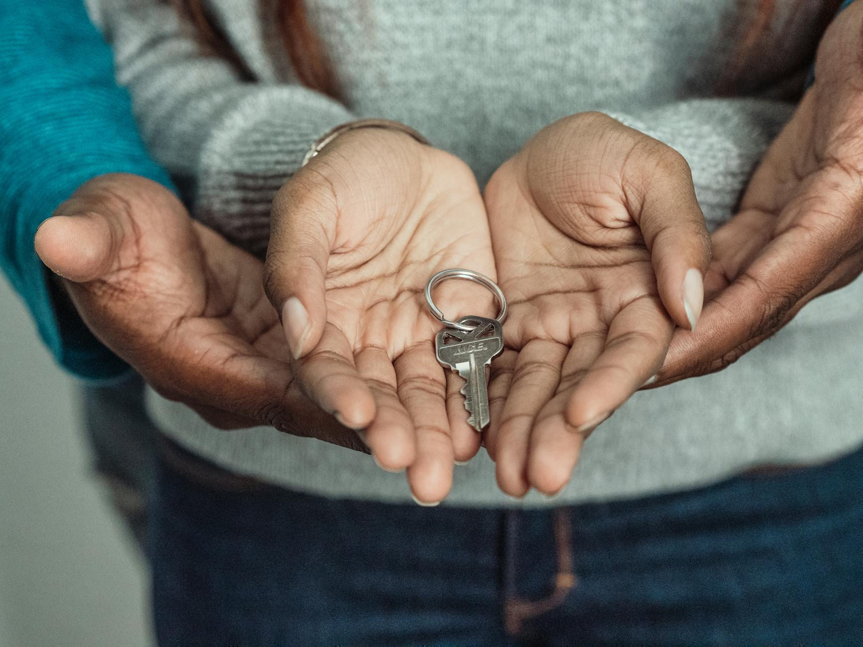 Close-up of a couple sharing a key, symbolizing new home ownership. on The Smart Home Buyer