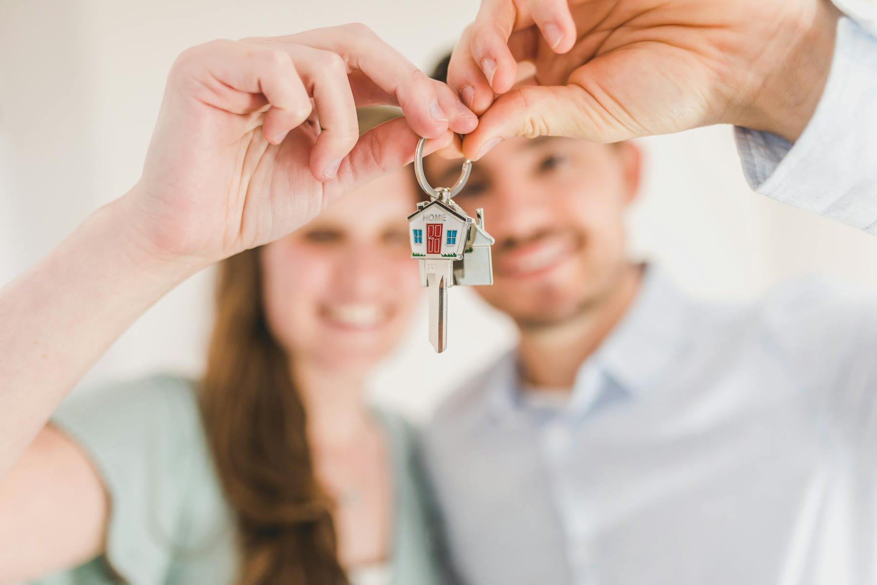 Young couple holding keys to their new home, symbolizing a fresh start and investment in real estate. on The Smart Home Buyer