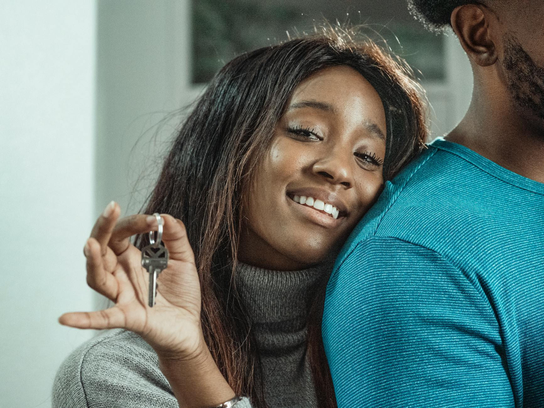 A joyful couple celebrating their new home purchase by holding keys. on The Smart Home Buyer