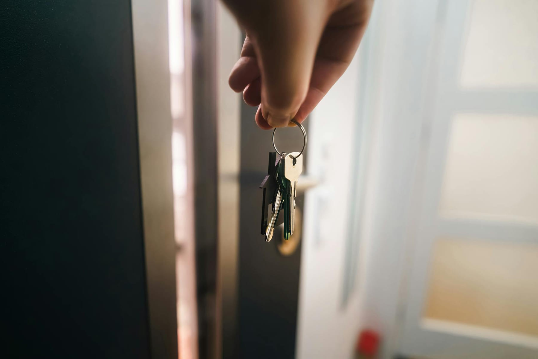 Close-up of a hand holding keys, symbolizing home ownership or rental entry. on The Smart Home Buyer
